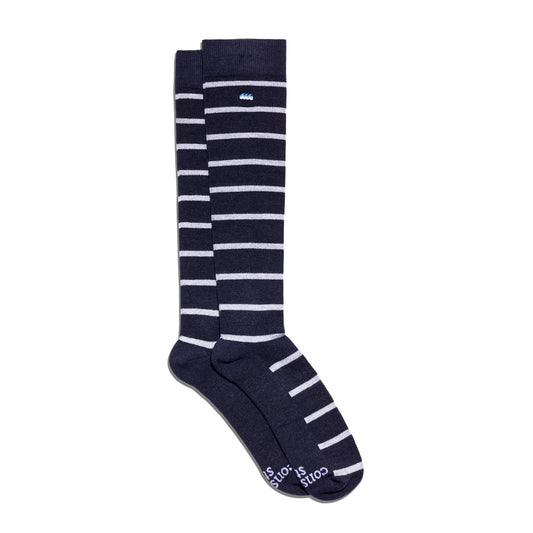 Navy blue knee-high socks with white stripes on a white background