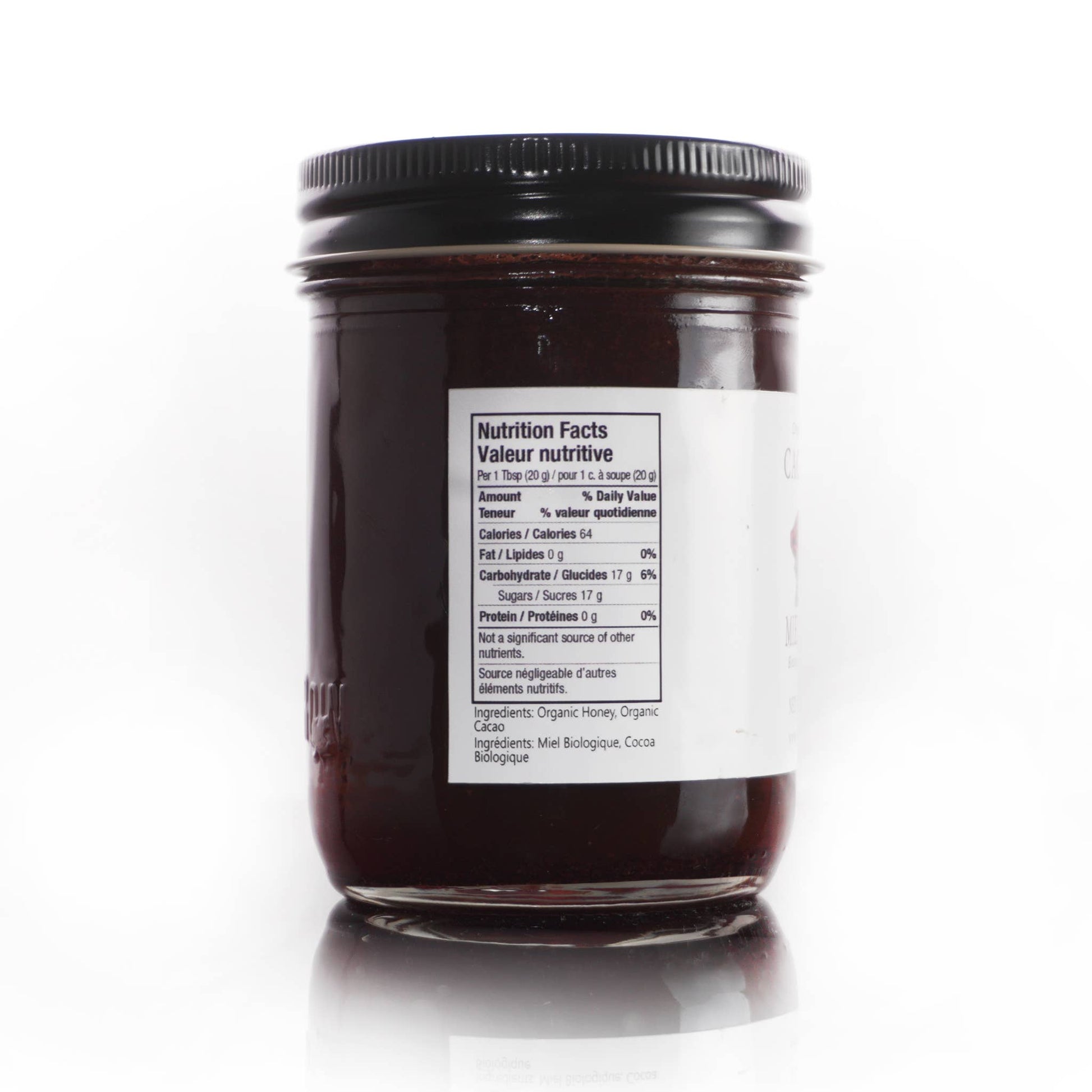 Jar of chocolate honey spread with a nutrition label on a white background
