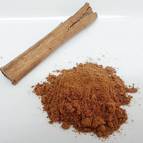 Cinnamon stick and ground cinnamon on a white background