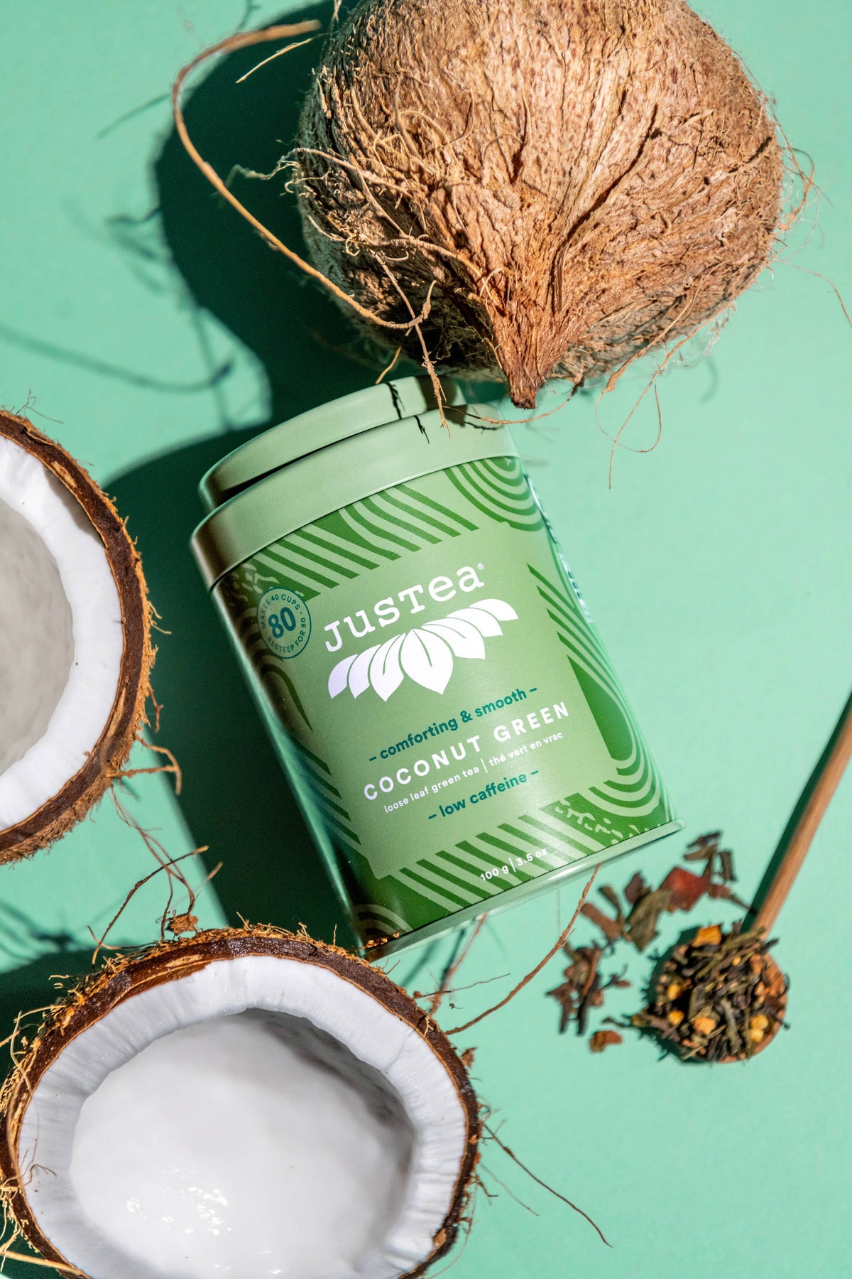 Justea coconut green tea canister with coconuts on a green background