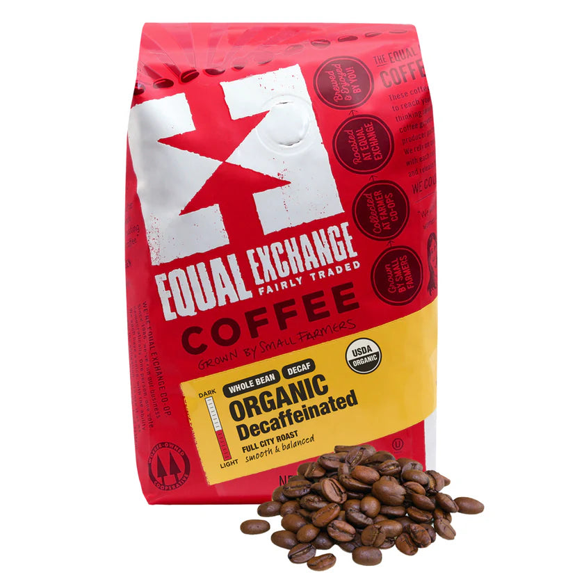 Red bag of Equal Exchange Organic Decaffeinated whole bean coffee with coffee beans on a white background