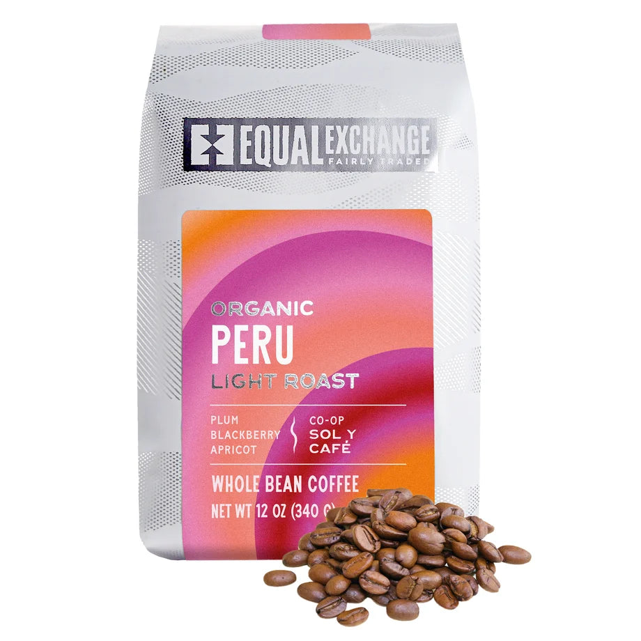 bag of peru light roast coffee beans in white bag with pink and orange accents with pile of beans beside