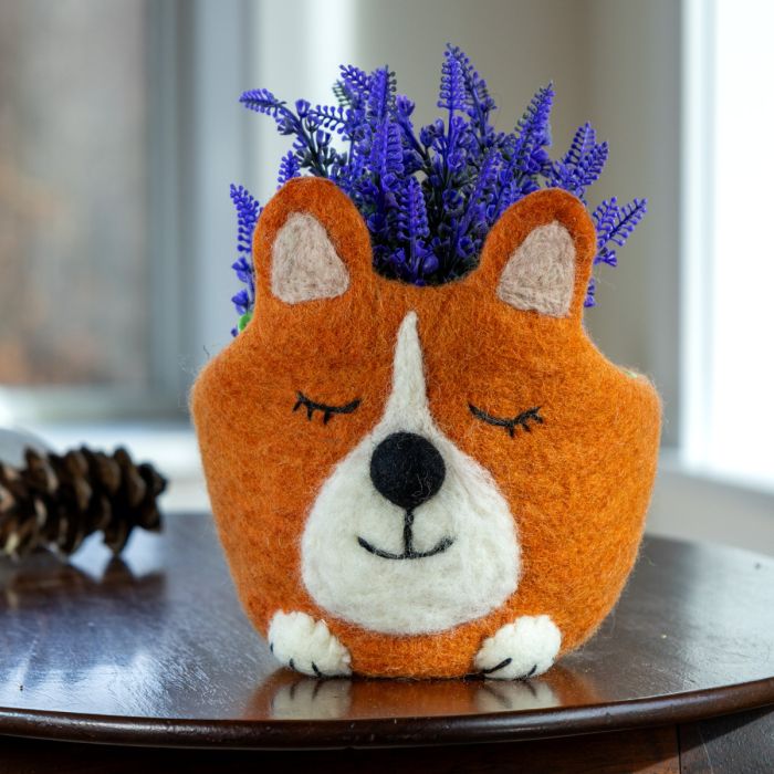 Felted corgi-shaped planter with lavender on a wooden surface