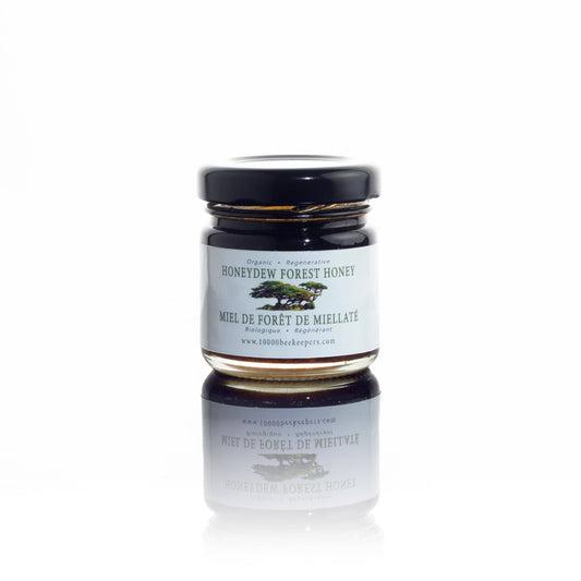 Jar of honey with a label on a white background