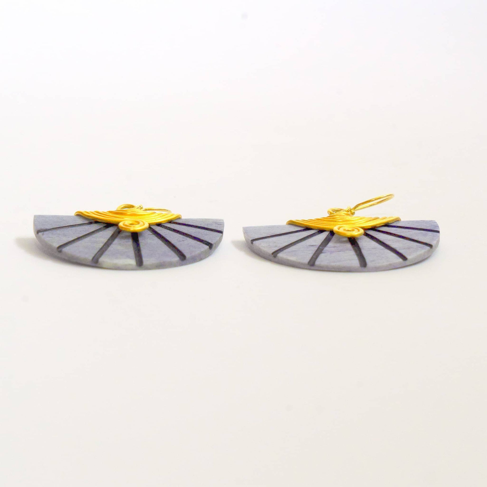 Pair of earrings shown from their bottom edge. Gray and yellow design on a white background