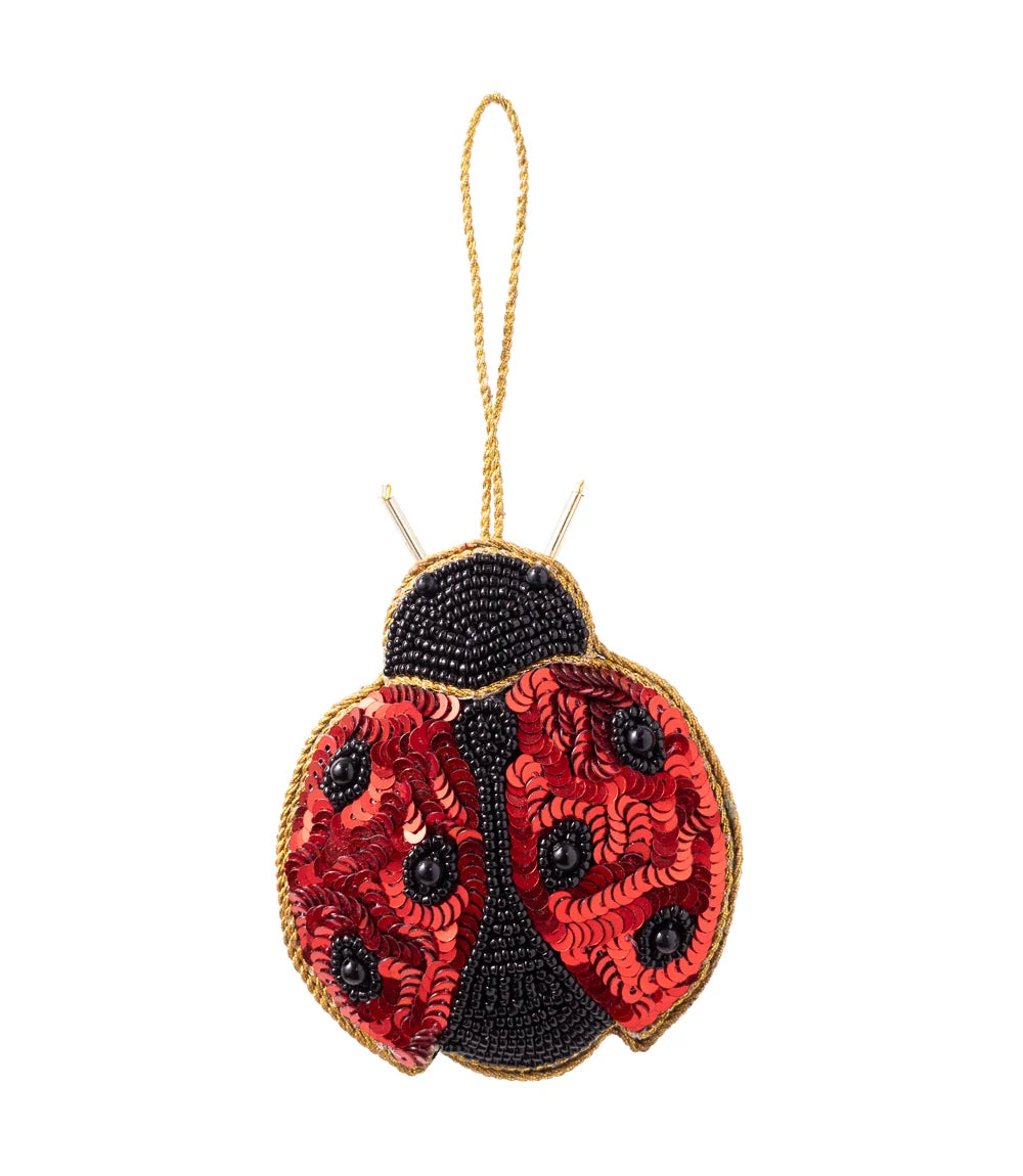 Red and black ladybug ornament embellished with sequins and glass beads with a gold hanging loop.