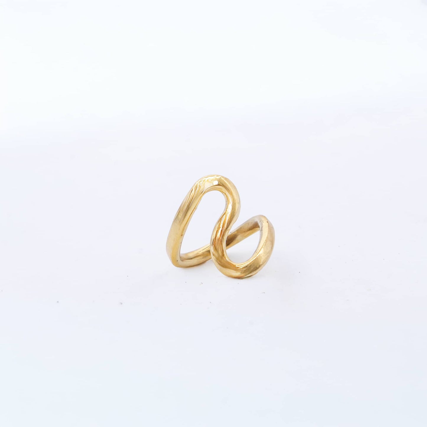 Gold ring with a unique design on a white background