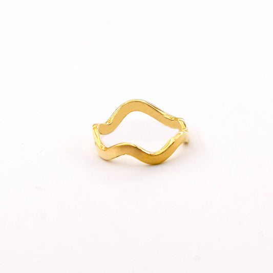 Gold ring with wavy design on a white background