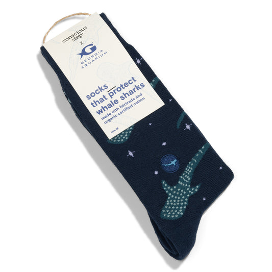 Navy sock with whale shark design and conscious step packaging on a white background