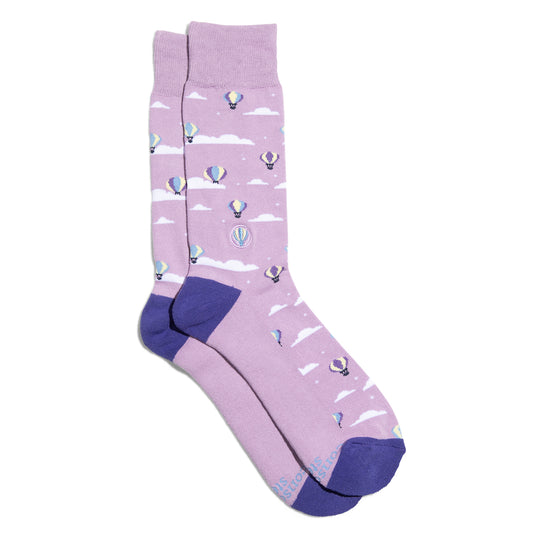 Purple socks with hot air balloon pattern on a white background