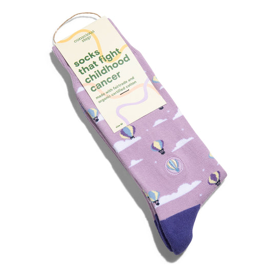 Purple socks with hot air balloon design and a visible tag on a white background