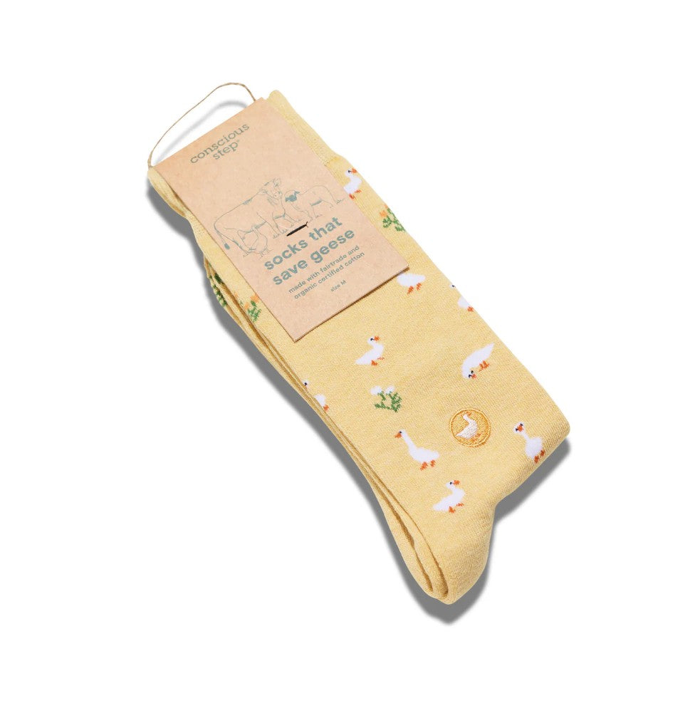 Yellow socks with duck pattern and packaging on a white background