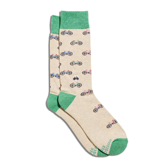 Beige socks with bicycle pattern and green accents on a white background