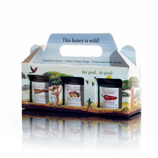 Honey packaging with three jars and a decorative box on a white background