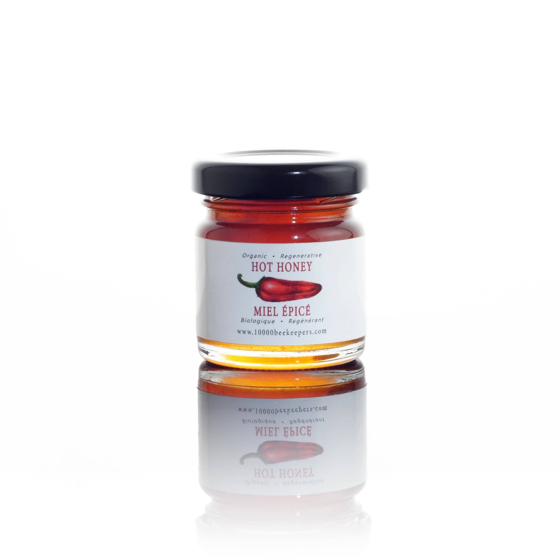 Jar of hot honey with a label on a white background