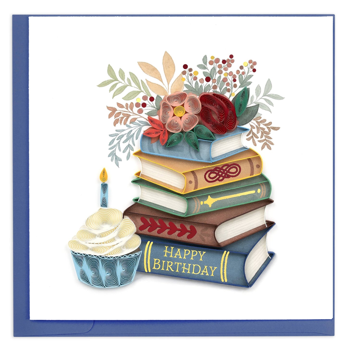 A blue and white cupcake sits next to a stack of books covered with flowers.