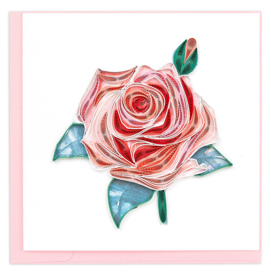 A large rose in several shades of pink surrounded by three green leaves and a rose bud. 