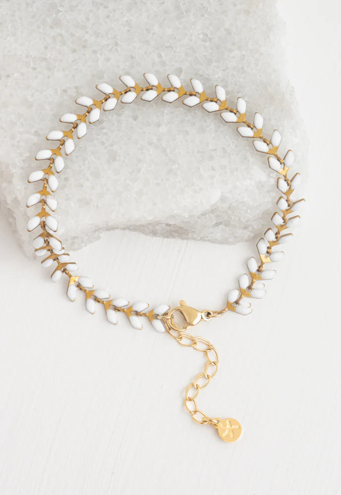 Linked bracelet with small ivory enamel dots along the chain. Extra links available to extend.