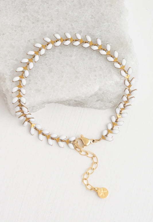 Linked bracelet with small ivory enamel dots along the chain. Extra links available to extend.