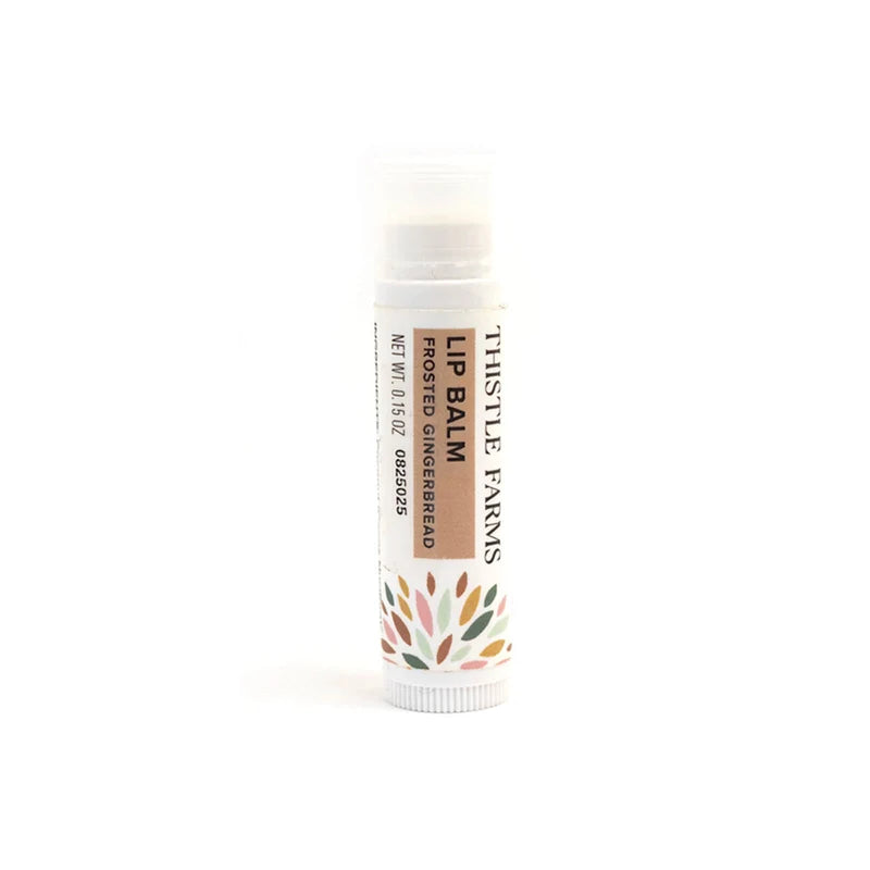 White Lip balm tube with tan decoration on a white background