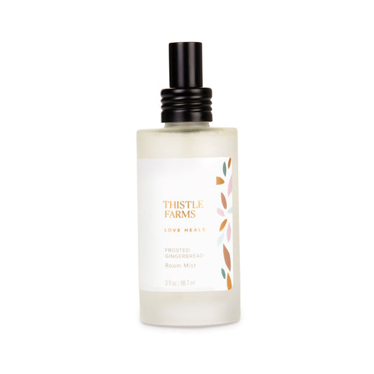 Frosted glass bottle with black lid on a white background