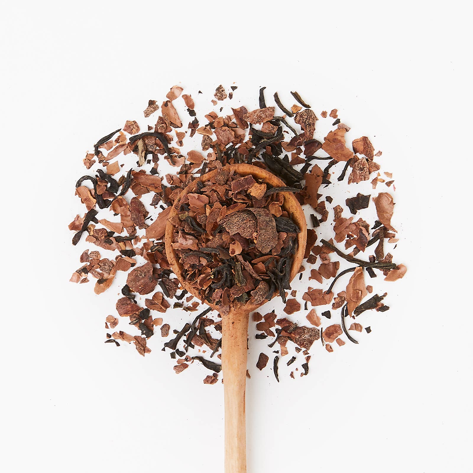 Wooden spoon with tea leaves on a white background