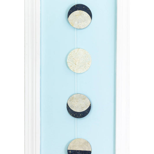 Decorative hanging with moon phases on a light blue background