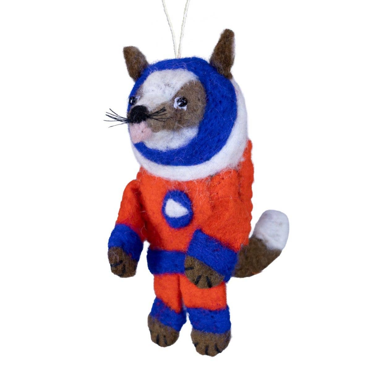 A felted wool hanging ornament shaped like a dog wearing a bright red, blue, and white astronaut suit, suspended by a thin white string against a plain white background.