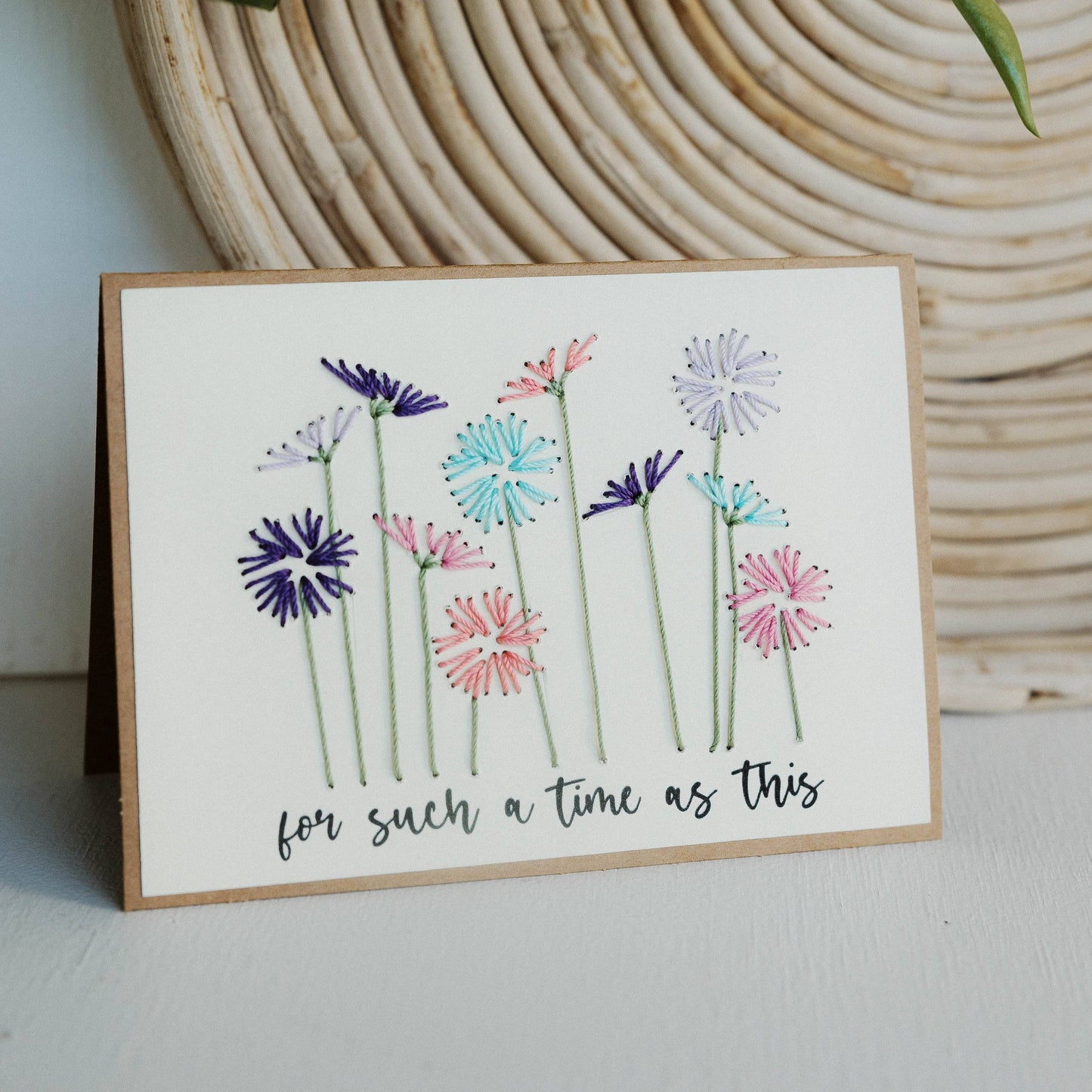 Card with floral design and text 'for such a time as this' against a woven bamboo background