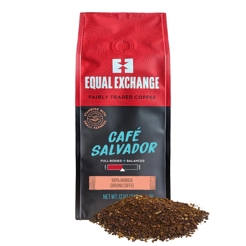Red and black Equal Exchange Cafe Salvador coffee bag with ground coffee in front