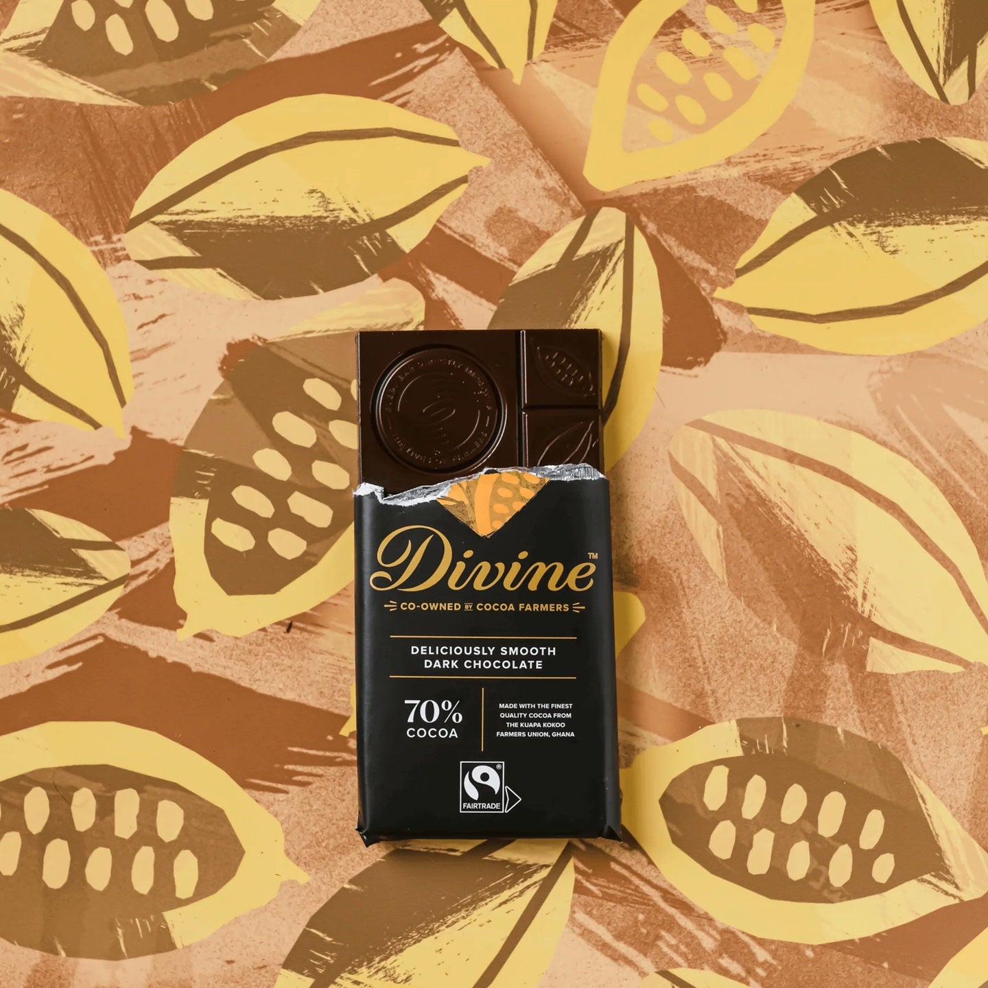 Divine chocolate bar on a background with cocoa bean illustrations