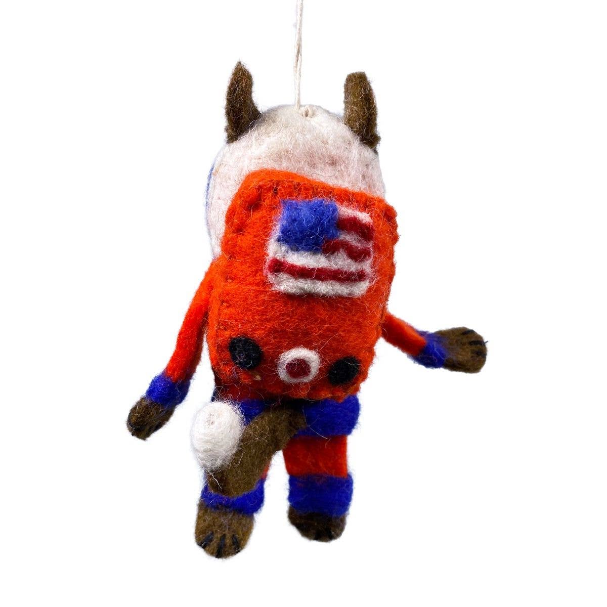 A hand-felted wool animal ornament, decorated with an American flag patch on the back, a white face, and red, blue, and brown felted wool details, shown against a plain white background.