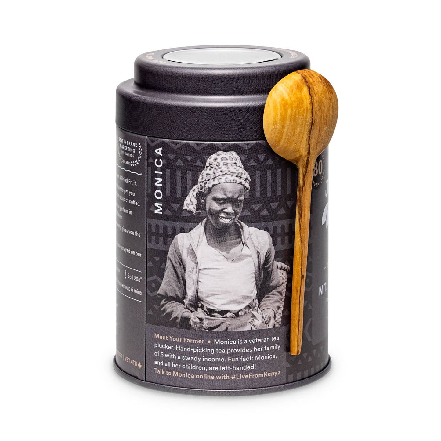Tea canister with wooden spoon featuring a picture of Kenyan farmer partner, Monica.