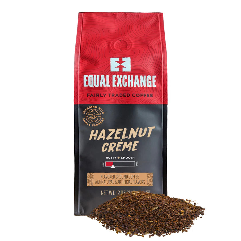 Red and black package of Equal Exchange Hazelnut Creme coffee with ground coffee in front