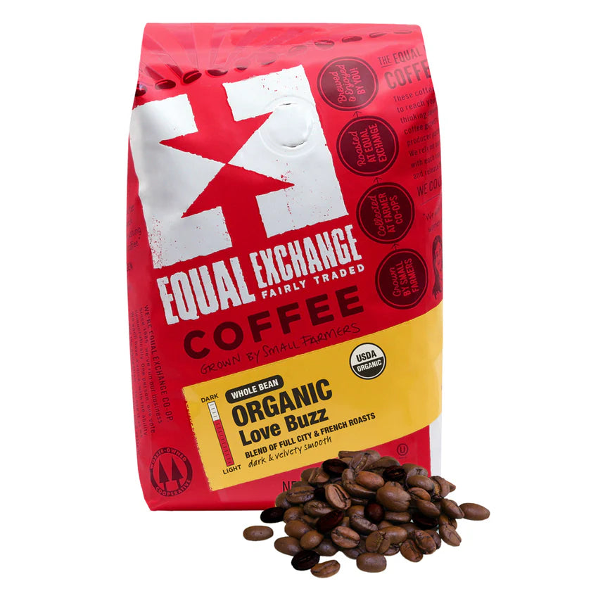 Red bag of Equal Exchange Organic Love Buzz coffee with coffee beans on a white background