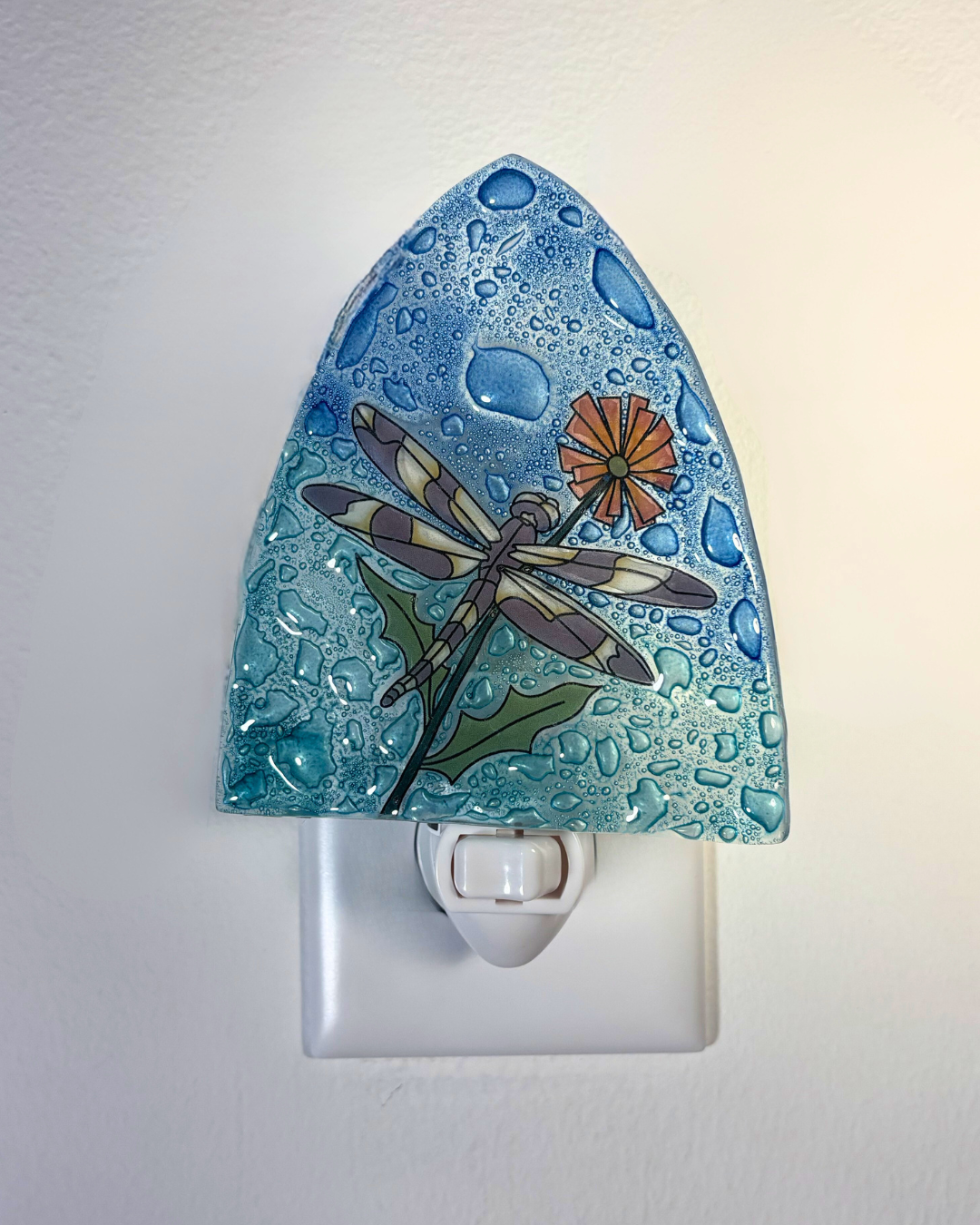 Decorative night light with a dragonfly design on a white background