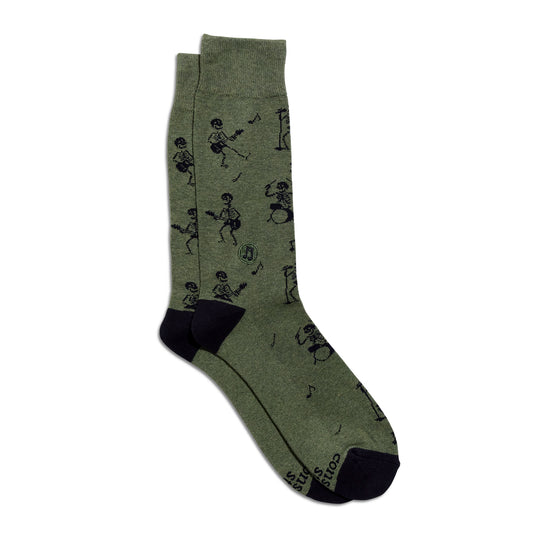 A pair of crew socks in heathered olive green with a black graphic print of stick-figure skeletons playing musical instruments, finished with solid black heels, toes, and cuffs.