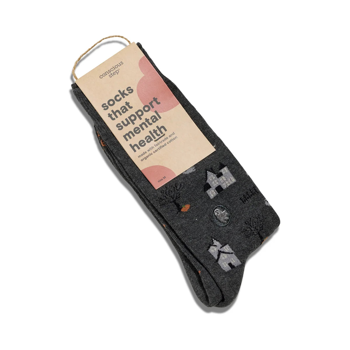 Dark grey socks with spooky houses, ghosts, moons, trees and pumpkins in a brown package with black type