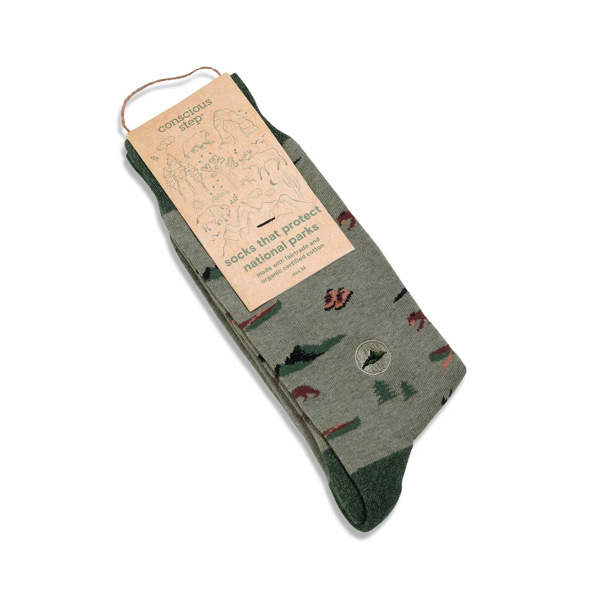 Conscience step socks. Light green field with dark green toes, heals and top. Small wild animals and outdoor gear knitted into the light green field. Wrapped in brown packaging with green writing.